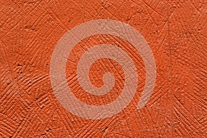 Background, texture: orange, deliberately coarse plastered wall of a building closeup