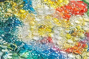 Background texture; pattern. Cloth with glued lace stripes. Multicolored lace with sparkles; cording and metallic embroidery. photo