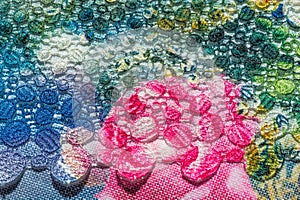 Background texture; pattern. Cloth with glued lace stripes. Multicolored lace with sparkles; cording and metallic embroidery. photo