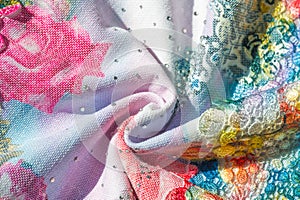 Background texture; pattern. Cloth with glued lace stripes. Multicolored lace with sparkles; cording and metallic embroidery. photo