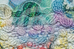 Background texture; pattern. Cloth with glued lace stripes. Multicolored lace with sparkles; cording and metallic embroidery. photo