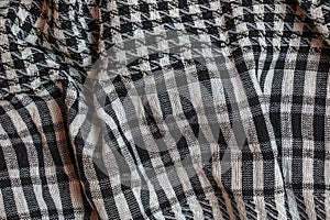 Background texture, pattern. Scarf wool like Yasser Arafat. The Palestinian keffiyeh is a gender-neutral checkered black and white