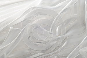 Background texture, pattern. White silk fabric, with a light strip. Closeup of rippled white silk fabric. Smooth elegant golden s