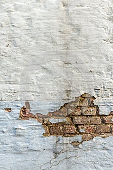 Background texture of peeling plaster on an old wall. Vertical