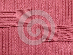 Background texture of pink knitted wool fabric