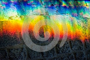 Background or texture from a rainbow on a concrete tile. Light change through glass. Prism.