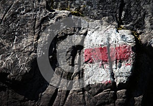 Red tourist sign on limestone rock