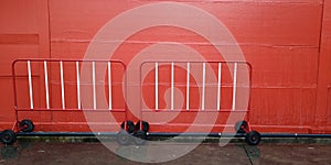 Background texture red and white color has traffic barrier a font of the wall with 2 traffic barrier