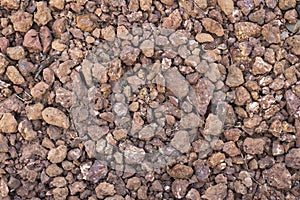 Background texture of a road or sidewalk made of red gravel stone