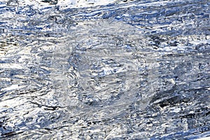 Background, texture - wavy surface of melting ice