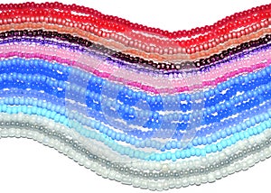 Background of threads with blue, pink, white and silver beads