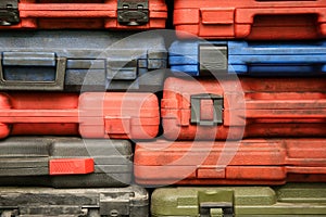 Background of toolboxes of different sizes and colors.