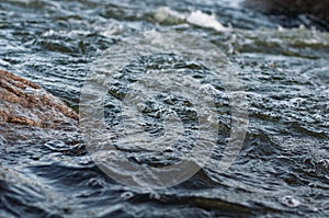 Background, top view, rapid flow river with dark blue water and white foam waves