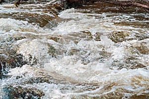 Background, top view, rapid flow river with dark blue water and white foam waves