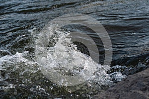 Background, top view, rapid flow river with dark blue water and white foam waves