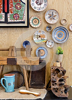 Background with traditional elements, clay plates, pickle jars and traditional crafts and handmade wooden spoons.