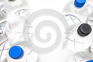 Background of transparent spherical water bottles with colored caps. With copy space