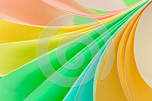 Background of twisted pastel multi-colored sheets of paper