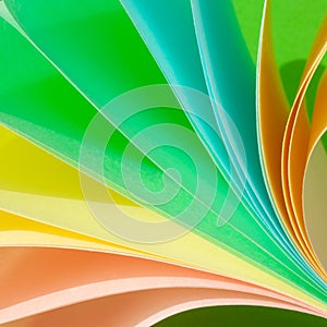 Background of twisted pastel multi-colored sheets of paper