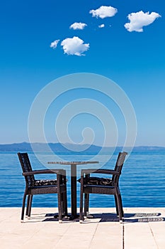 Background of two chairs and beach and small bag and table place