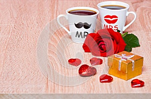 Background with two coffee cups, hearts, gift and rose flower