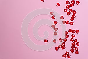 Background for Valentine`s day-hearts scattered on pink background, place for text, postcard for holiday