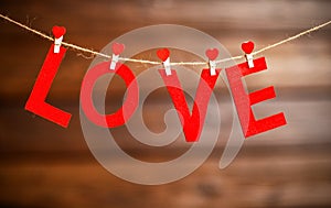 Background Valentine`s day. two red hearts and word Love on wooden