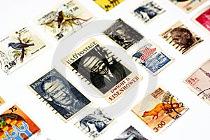 background of various old used postage stamps from different countries and times on a white background