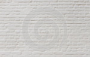 Background of vintage brick wall covered with white plaster