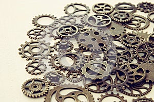 Background of vintage gears over wooden table, Aged mechanical clock wheels