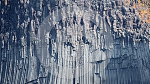 Background with volcanic basalt columns. Stone formation.