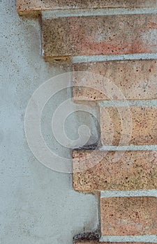 Background of a wall of brick and stone cemented with concret.