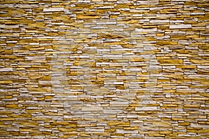 The background of the wall, lined with artificThe background of the wall, lined ial stone irregular rectangular white and yellow.