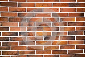 The background of the wall is made of masonry bricks of brown yellow burnt color with white seams. Backgrounds textures