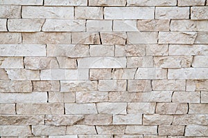 The background of the wall is made of strips of natural cream marble with a beautiful pattern of cream-colored stone. Backgrounds