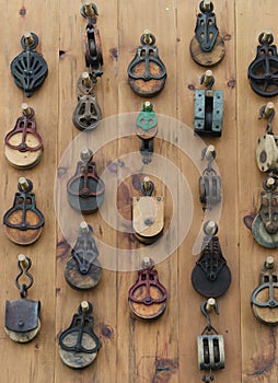 Background Wall of Old Metal and Wooden Pulleys