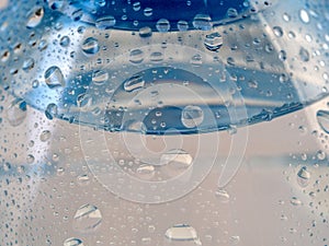 Background with water drops on a plastic bottle.