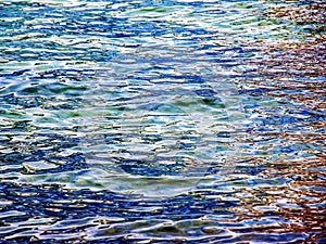 Background of the water of Lake Traunsee in the coastal area. Colorful texture of stones under water