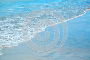 Background of waves beating on a sandy beach in stormy weather