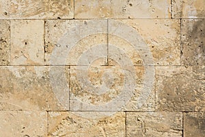 Background weathered beige stone wall