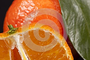 Background of whole fruits of mandarin orange with green leaves