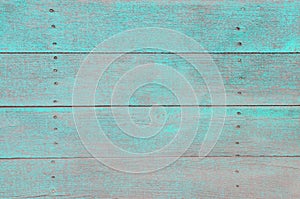 Background of wood boards with old paint of turquoise