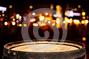 Background of wooden barrel in front of abstract blurred restaurant lights