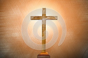 Background of wooden cross on bright light flare background