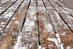 Background wooden surface covered with snow and ice
