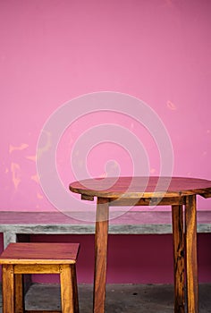 Background with wooden table and grunge pink wall