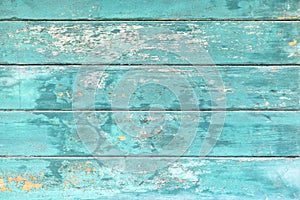 Background with wooden teal blue colored old weathered planks with chipped paint