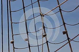 Background wrapped and sealed shroud from an old tallship, rope and chain against a beautiful blue sky