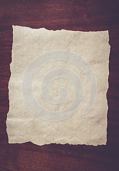 White sheet of paper on a wooden background