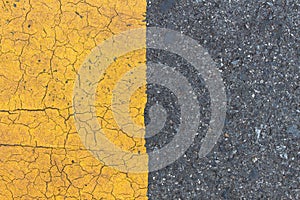 Background of yellow black strips . Dark grey asphalt road divided by yellow pain